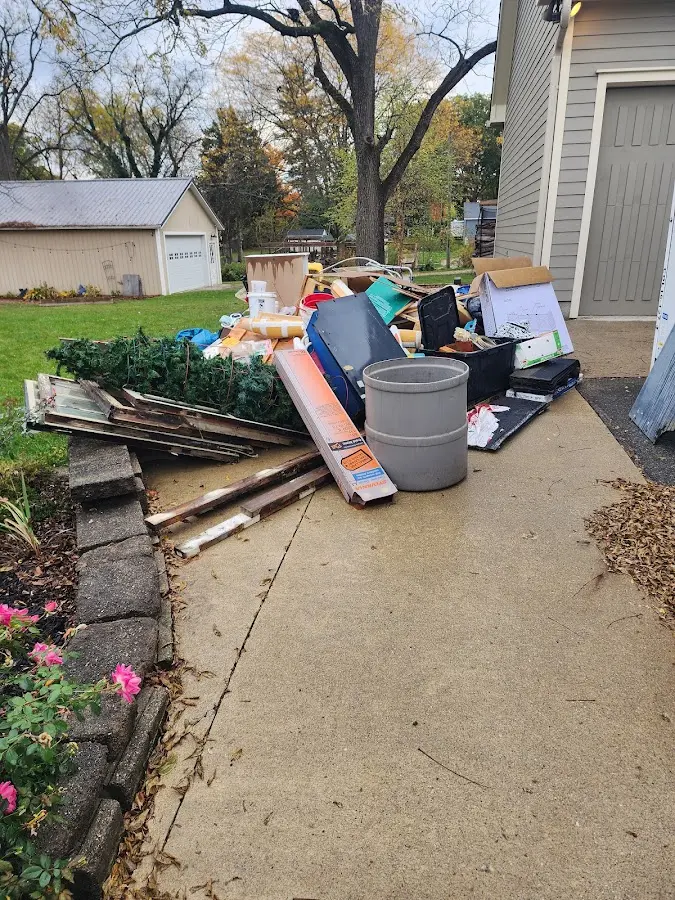 Dumpster being loaded with debris for 12 Yard Dumpster Rental in Dublin